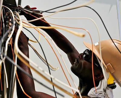 An electrician working on electrical wiring